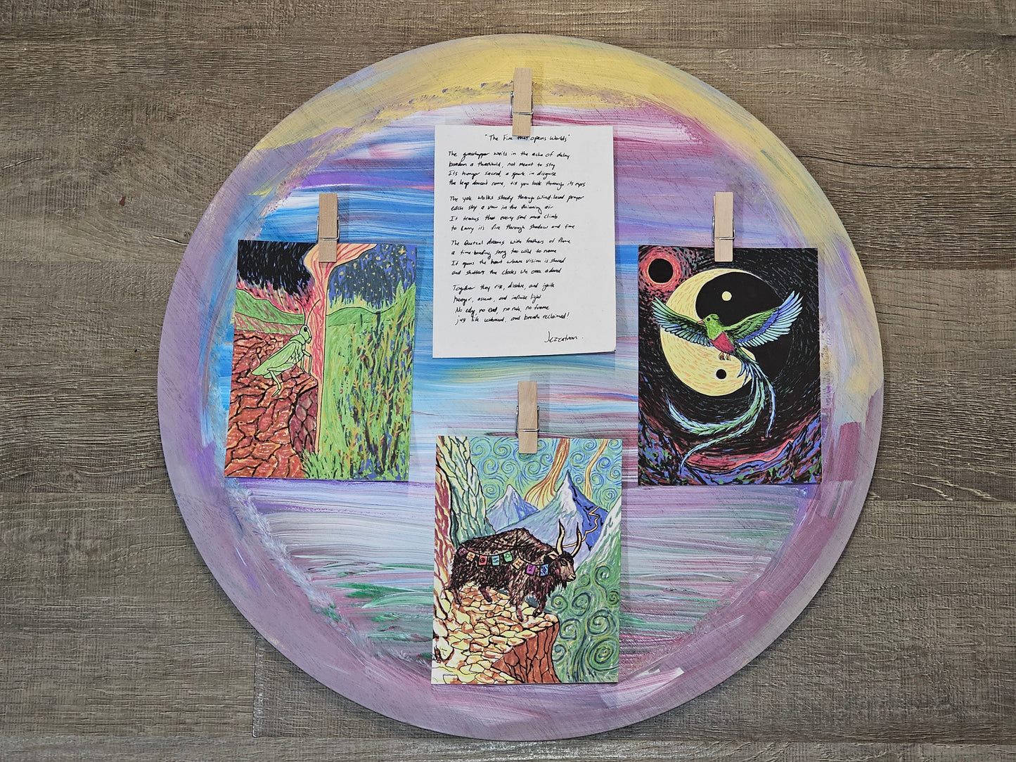 hand-painted circular frame with grasshopper yak quetzal and handwritten poem